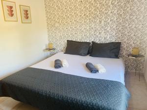 a bedroom with a bed with two pillows on it at Skopelos Inn in Stafylos