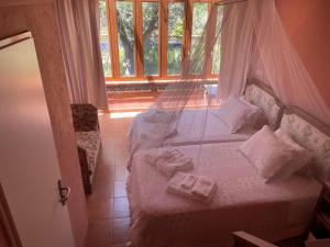 a bedroom with a bed with a mosquito net at Lovely 4-Bed Cottage near Pedrogao Grande in Pedrógão Grande