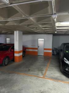 a parking garage with two cars parked in it at Vivir en el Campus de la Salud in Granada