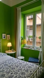 um quarto verde com uma cama e uma janela em B&B Stella Scugnizza em Nápoles