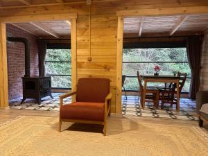 a living room with a chair and a table at Ayder Villa Gencal King in Ayder Yaylasi