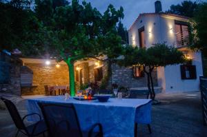 a table in front of a house at night at Villa Pounta Family in Glossa