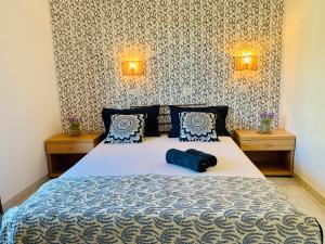 a bedroom with a large bed with two night stands at Skopelos Inn in Stafylos