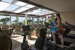 two women riding on a treadmill in a gym at Savoy Beach Hotel & Thermal Spa in Bibione