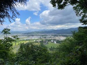 a view of a city from a hill with trees at Urasa Cottage @ Snow Countryside in Minami Uonuma