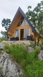 a house on a rocky hill with chairs in front at Martin in Nikšić