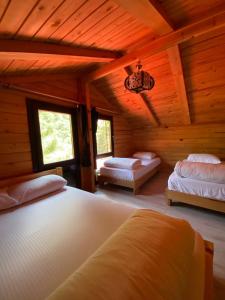a bedroom with two beds in a wooden cabin at Ayder Villa Gencal in Ayder Yaylasi