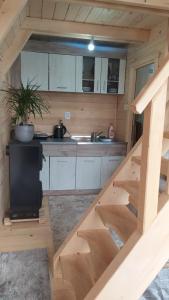 a small kitchen with a staircase in a tiny house at Martin in Nikšić