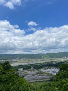 a view of a town with a river and trees at Urasa Cottage @ Snow Countryside in Minami Uonuma