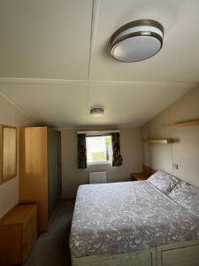 a bedroom with a large bed and a ceiling at Seaview Holiday Rentals - Seawall in Whitstable
