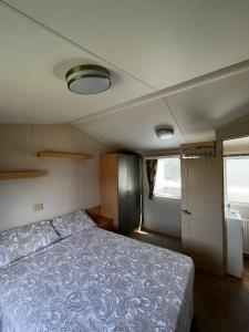 a bedroom with a bed in a small room at Seaview Holiday Rentals - Seawall in Whitstable +8 photos