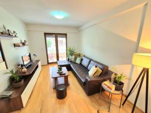 a living room with a couch and a table at Amsterdam Apartment Strumica in Strumica