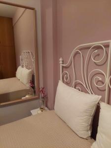 a bedroom with a white bed with a mirror at Boho Zen Retreat in Agia Pelagia +13 photos