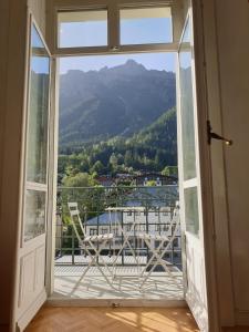 an open window with a view of a mountain at Majestic T2 calme, spacieux, central, avec parking in Chamonix-Mont-Blanc