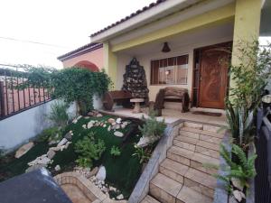a small garden in front of a house at Hostel Sideral in Campo Grande