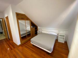 Łóżko lub łóżka w pokoju w obiekcie Duplex en Sanxenxo con piscina y vistas al mar