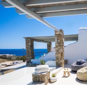 a view of the ocean from the balcony of a villa at Cavo Blue Villas in Elia Beach