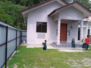a group of people standing in front of a house at Homestay Idaman B B with 2 room aircond 2 Quen Bed and Not Sharing Room -Privacy in Kuala Terengganu
