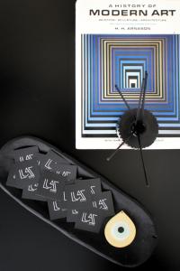 a remote control and a picture of a museum of modern art at Luaz Suites in Volos