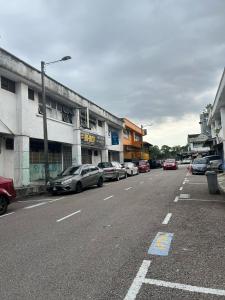 a street with cars parked on the side of the road at Jb Sojourn in Skudai +8 photos