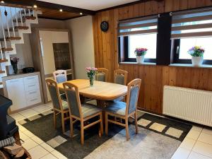 a dining room with a wooden table and chairs at Ferienhaus am Hennesee in Meschede