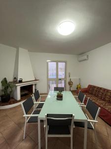 a living room with a table and chairs and a couch at Fusella Country House/Villa a Polignano Vista Mare in Polignano a Mare