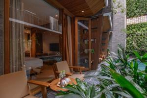 a living room with a table and some plants at Mai's Boutique in Danang