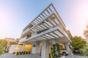 a white building with a large white pergola at Luaz Suites in Volos