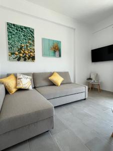 a living room with two couches and a flat screen tv at Utopia.luxuryapartment in Nea Potidaea