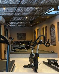 a room with a gym with cardio equipment in it at Dracos Hotel in Parga