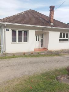 a white house with a brown roof at Apartments Suzana in Čapljina