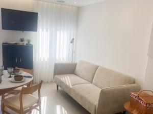a living room with a couch and a table at WakeUp - São Francisco in Valença