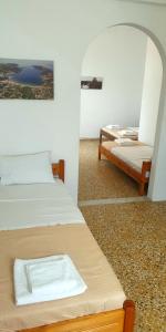 a room with two beds and a mirror at Ilias Place in Ios Chora
