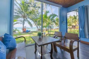 a dining room with a table and a view of the beach at Seafar Resort in Ko Kood