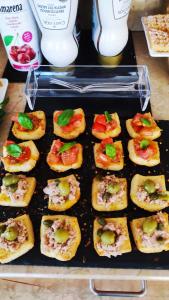 a tray of mini appetizers with tomatoes on it at Hotel Virginia in Garda