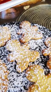 a group of donuts with powdered sugar on a plate at Hotel Virginia in Garda