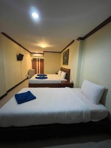 a hotel room with two beds with towels on them at Blueskyhouse Patong in Patong Beach +92 photos