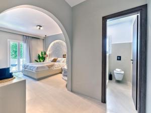 a bedroom with a bed and a mirror at Paridian Elegant Living in Kampos Paros