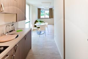 a kitchen with a sink and a table at Residence Lenno in Lenno