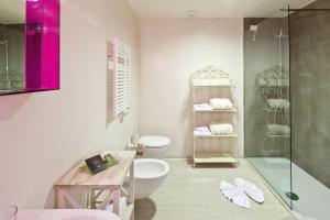 a bathroom with a toilet and a glass shower at Residence Lenno in Lenno