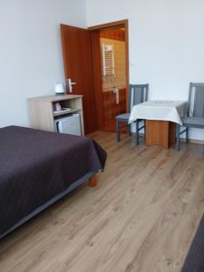 a bedroom with a bed and a table and chairs at Korwin in Rewal