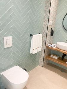 a bathroom with a toilet and a sink at WakeUp - São Francisco in Valença