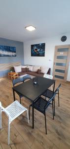 a table and chairs in a living room with a couch at Sauna 32 in Vítkov