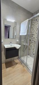 a bathroom with a shower and a sink at Sea Breeze Penthouse and Terrace Qawra St Paul's Bay in St Paul's Bay +22 photos