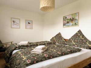 a bed with blankets and pillows on top of it at Ferienwohnung Jack-Inn in Oberkirch