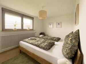 a bedroom with two beds and a window at Ferienwohnung Jack-Inn in Oberkirch +25 photos