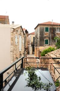 a glass table with a plant on a balcony at Burnelia Vacation Maisonette in Lefkímmi