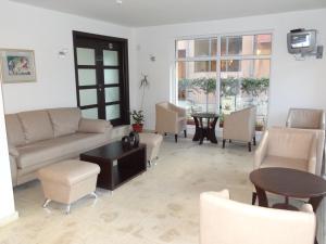 a living room with a couch and chairs and a table at Family нouse -Нotel Asai in Ravda