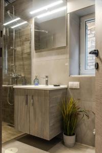a bathroom with a sink and a shower at Burnelia Vacation Maisonette in Lefkímmi +50 photos