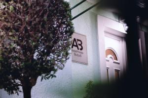 a building with a sign on the side of it at Apartmani Bijelic HN in Herceg-Novi